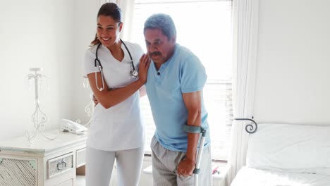 female doctor helping senior man to walk with walker 4k