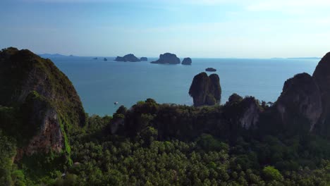 stunning aerial view of phra nang railay beach in krabi, thailand, showcasing its turquoise waters, limestone cliffs, and lush vegetation. spectacular aerial view flight overflight flyover drone
