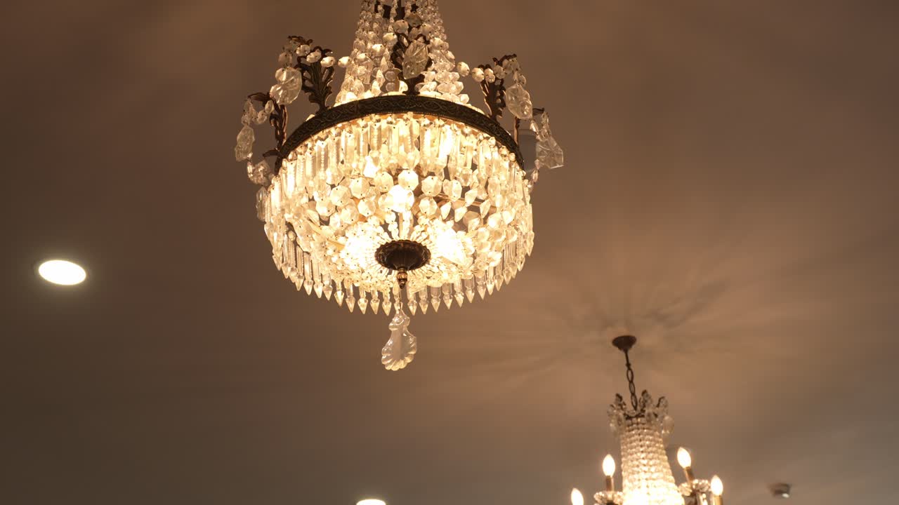 luxurious crystal chandelier casting warm light in sophisticated indoor setting