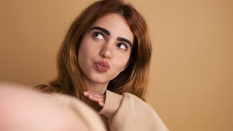sensual young woman blowing a kiss and posing