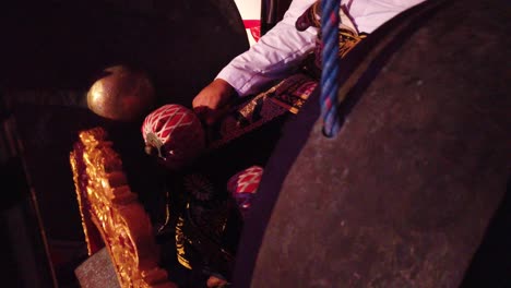 closeup gamelan musician plays gong percussion instrument east, southeast asia