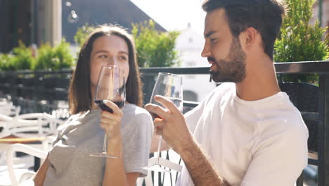 couple enjoying wine at an outdoor cafe