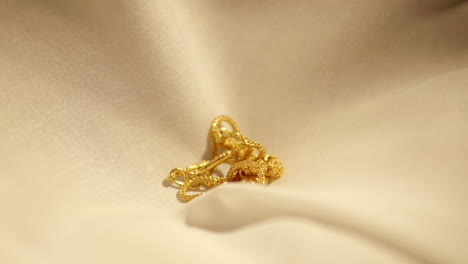 gold wedding necklace dropped on velvet cloth