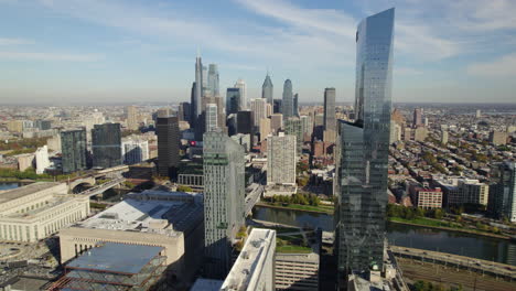 drone shot rising from west philadelphia, revealing the skylne on a sunny day