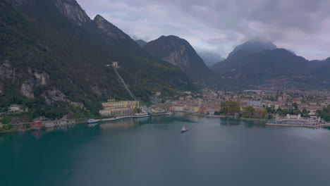 dolly in aerial shot approaching a passenger boat just leaving a beautiful, scenic place