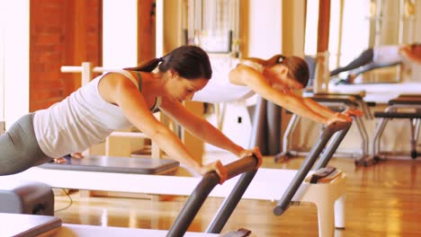 Women-exercising-on-gym-equipment