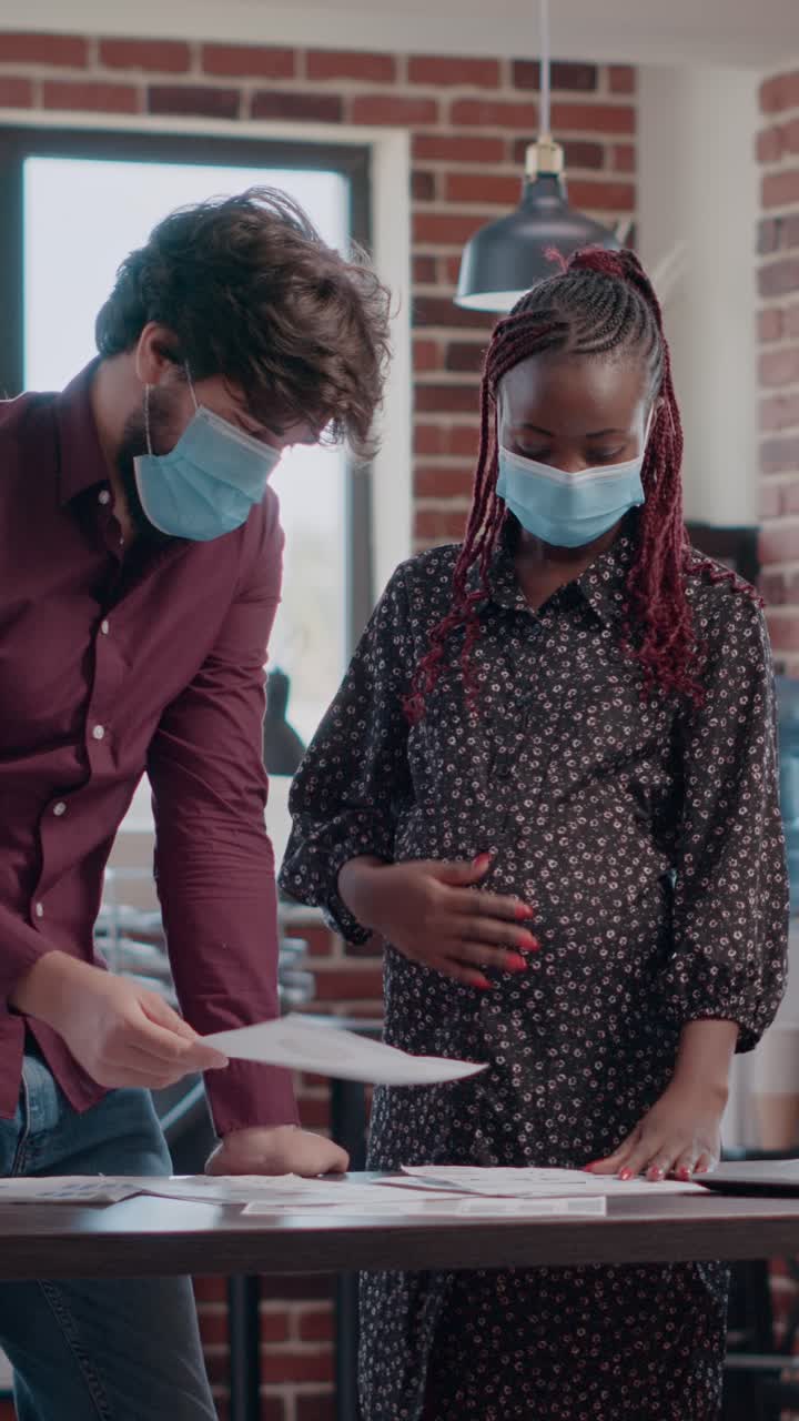 People wearing face masks in office