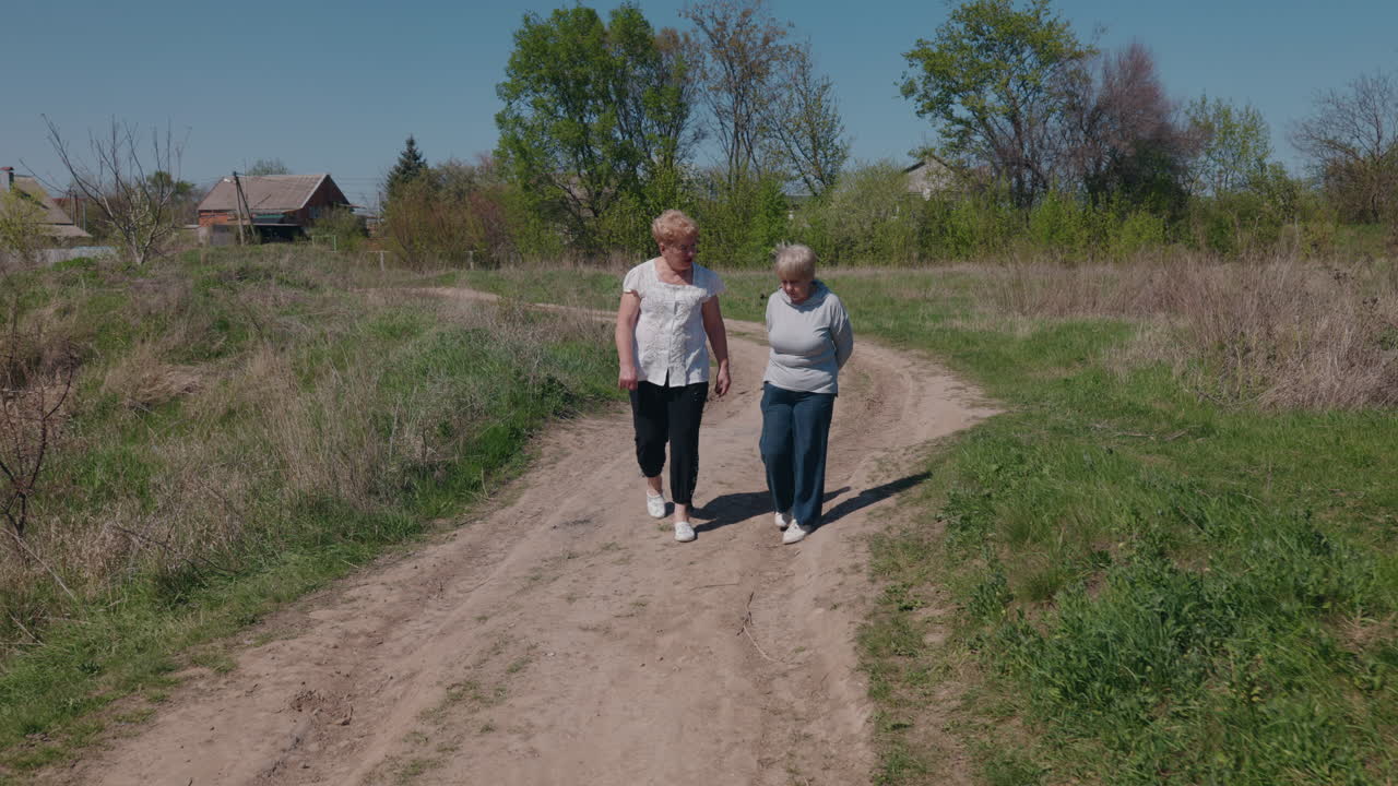 Two women walking on a rural road