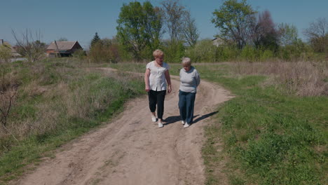 two women walking on a rural road