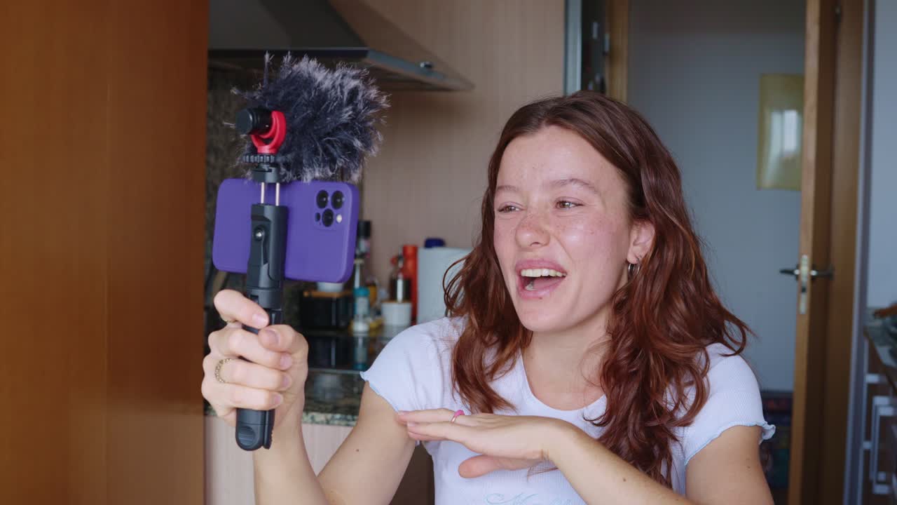 Woman vlogging in her kitchen