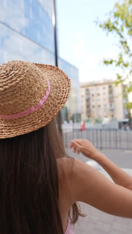 woman in straw hat and pink top