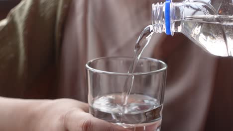 pouring water into a glass