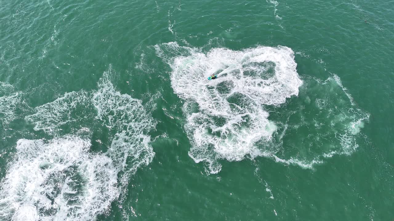 Jet ski Overhead birds eye drone aerial view circle’s make s shape in water