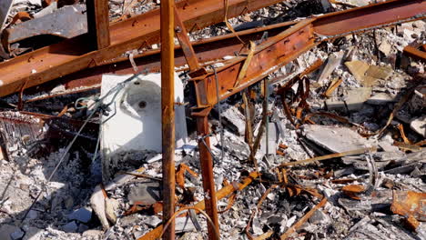 close-up of rusted metal and rubble from a collapsed or burnt structure
