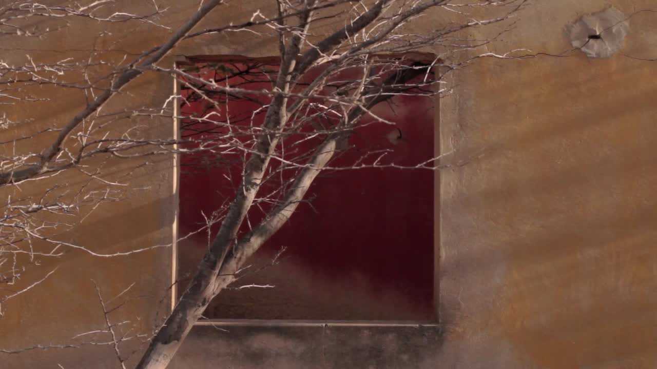 Close shot of a yellow window frame in the ghost town of Puerto , in northern Guajira, Colombia