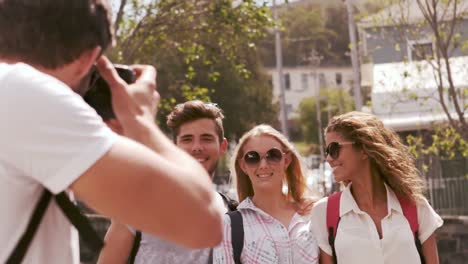 um homem hipster a tirar fotos dos seus amigos.