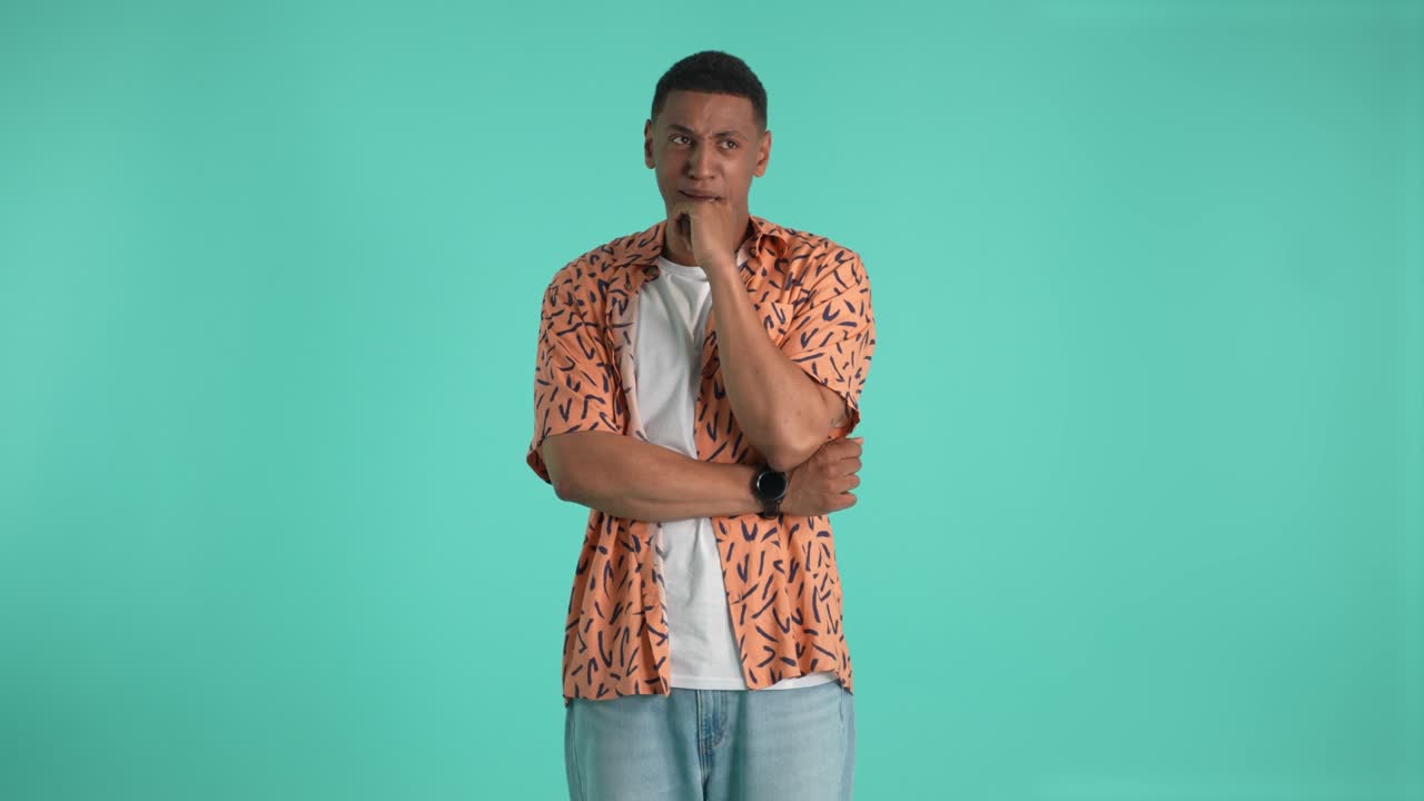 Sad young man crying isolated on studio background