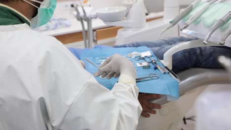 dentist using tools during treatment in clinic