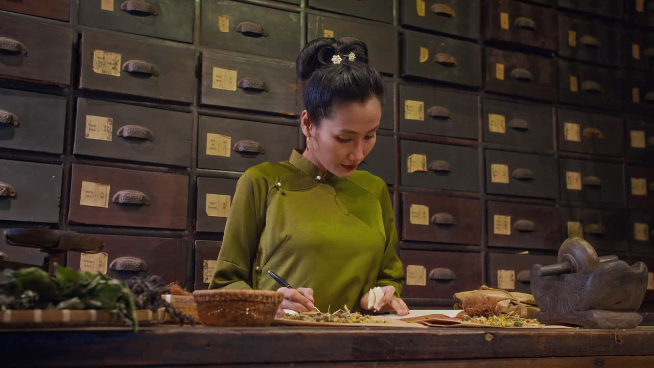 Female Herbalist Filling Prescription Consisting of Dried Ingredients