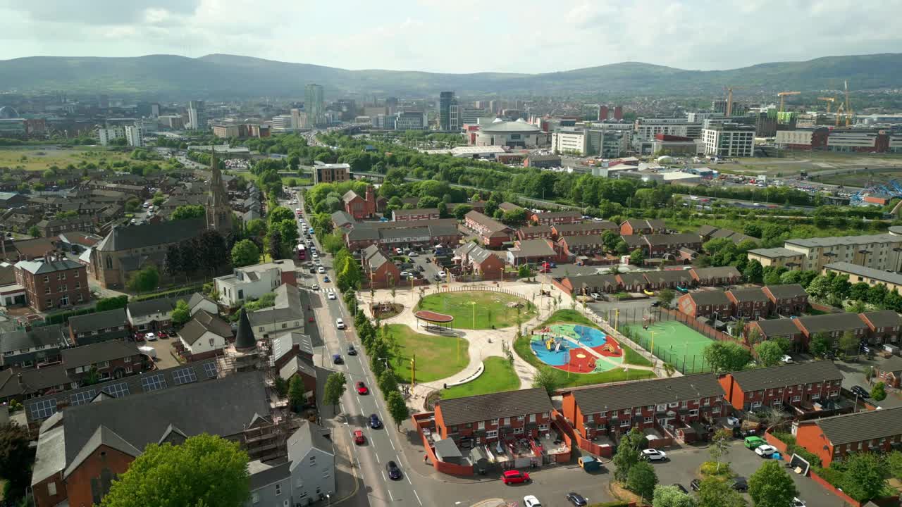 Wide reversing aerial video of the Newtownards Road in East Belfast, Northern Ireland on a bright sunny day. Filmed in 4K, 60FPS and with Rec709 color.