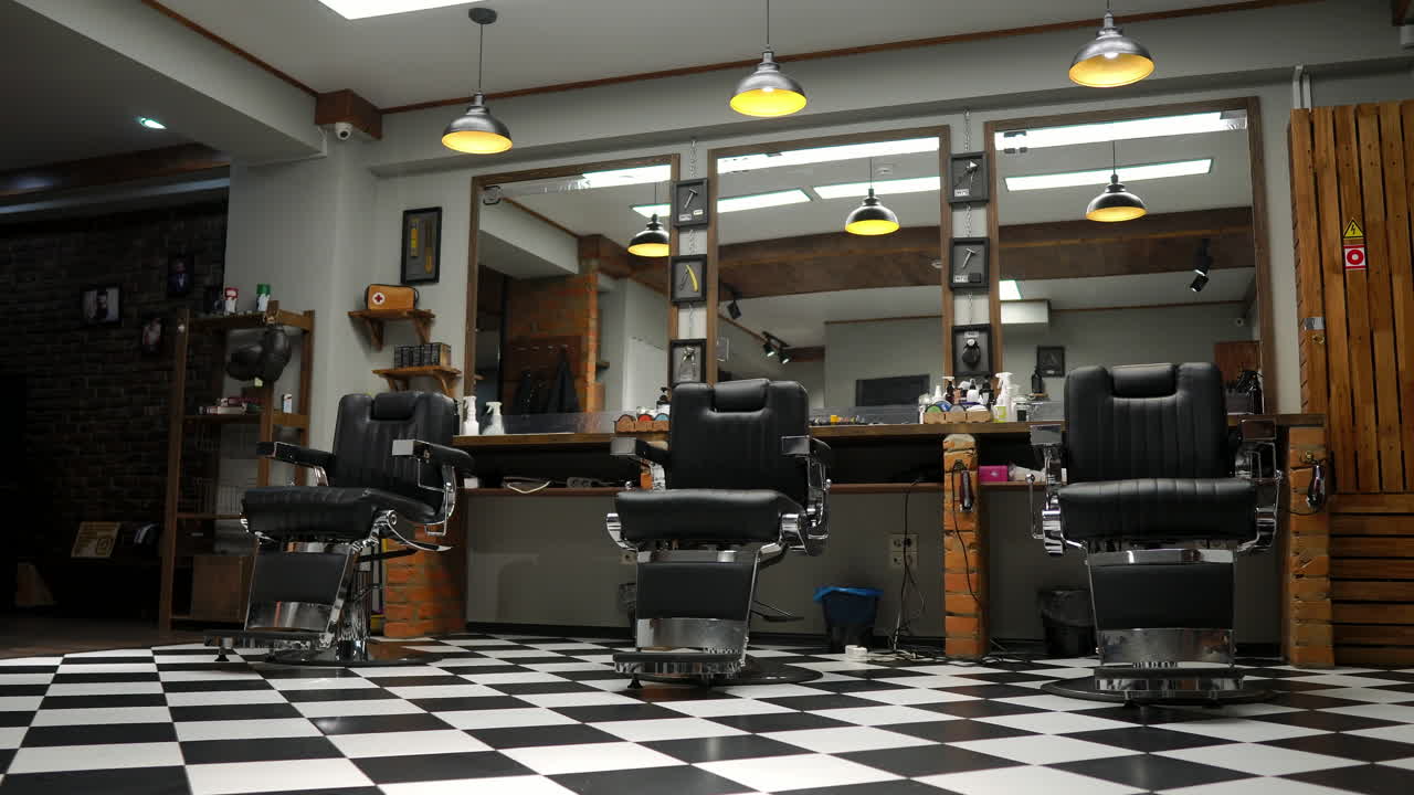 Interior of the men's Barber shop with brick walls and leather chairs with chrome handles
