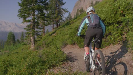 a mountain biker rides on a path near a forest 1