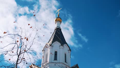 orthodox church tower with blue sky and clouds