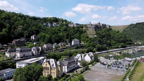 aerial flying drone shot of the rhine river valley and old architecture - including medieval castles, old buildings, and natural forested alpine hills