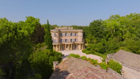 castle revealed, aerial drone view of an ancient tree unveiling château de castille in southern france