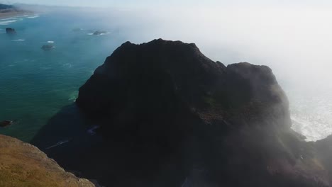 AERIAL:-View-from-far-above-flying-over-some-very-large-rock-formations-sitting-on-Oregon's-coastline