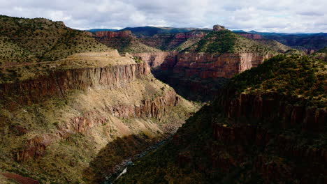 Disparo-De-Drone-Volando-Hacia-Abajo-Valle-Del-Cañón-Montañoso