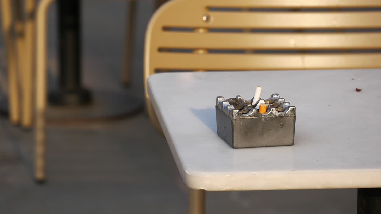 Ashtray with Cigarette Butts on a Table Outside