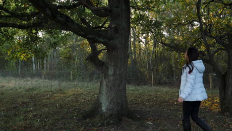 an asian woman hugging a tree