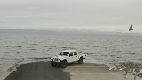 aerial shot of a white jeep gladiator in 4k