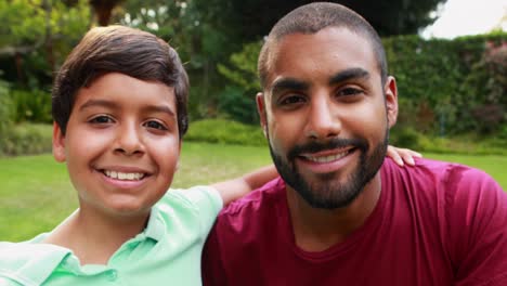 Portrait-of-father-and-son-standing-with-arm-around-4k