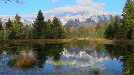 the grand teton mountains are reflected in a mountain lake 2