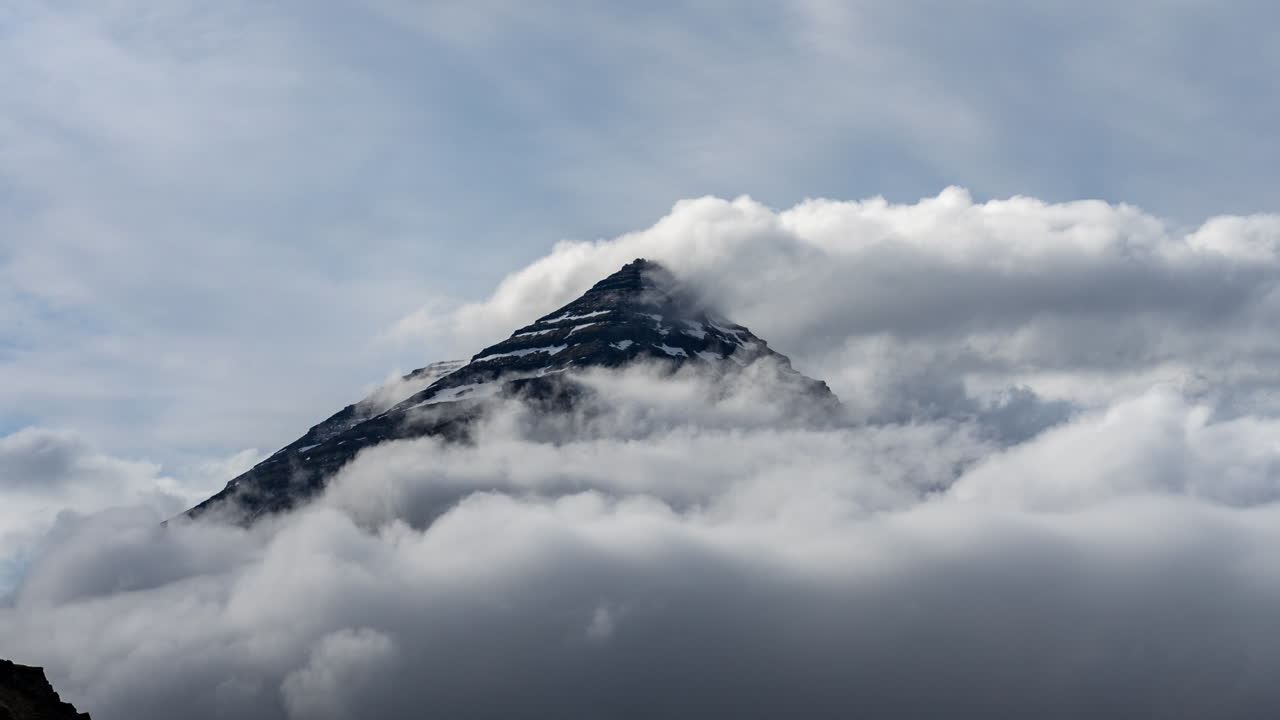 Timelapse of Clouds Moving Under Mountain Summit in Highlands of Iceland