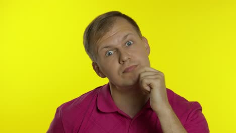 Portrait-of-man-posing-in-pink-t-shirt.-Crazy-handsome-guy-making-funny-faces,-play-with-his-lips