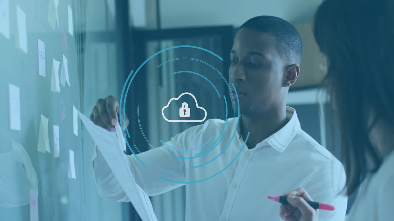 Discussing documents, business professionals with cloud security animation in office meeting