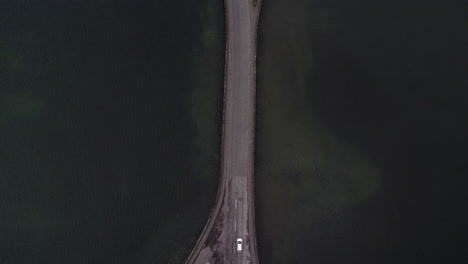 car crossing lagoa das sete cidades bridge, são miguel island, azores - aerial top view