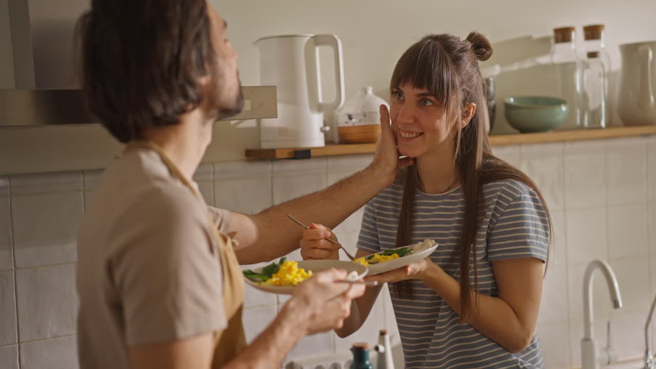 Couple Eating Scrambled Eggs in Kitchen