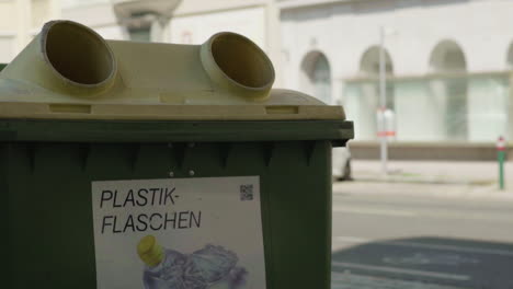 a plastic bottle recycling bin in an urban street