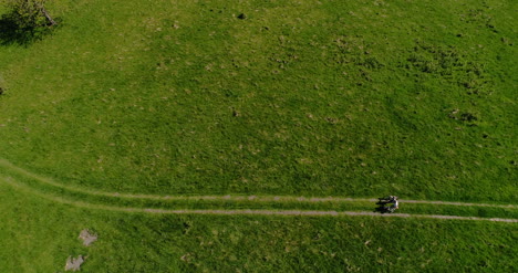 Aerial-View-Of-Two-Bicyclist-Walking-In-Mountains