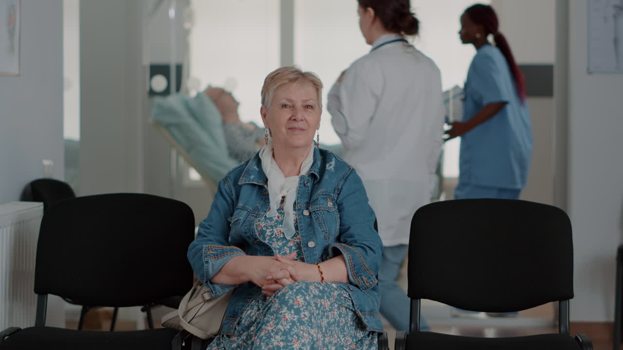 Portrait of aged woman sitting on chair in waiting room