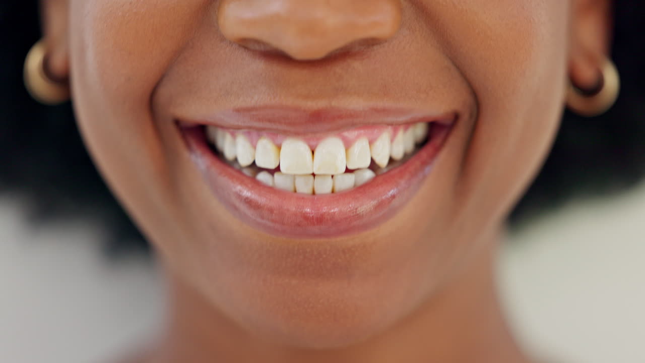 Closeup of smiling dentist showing white teeth