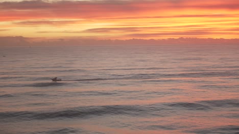 speed boat sailing on ocean water at sunrise sunset, beautiful skyline sky golden