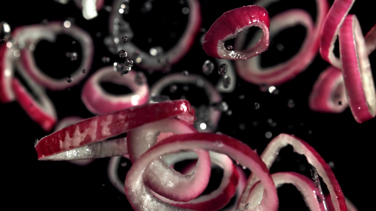 Fresh Red Onion Rings Falling in Super Slow Motion