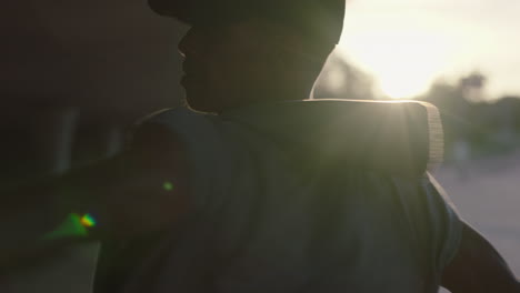 dancing man young mixed race breakdancer performing spin practicing modern hip hop dance moves in city at sunset