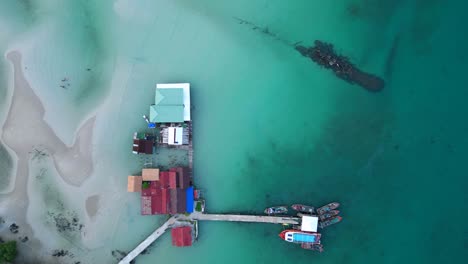 cambodia koh rong island, capturing the essence of tropical paradise with its lush palm trees, vibrant turquoise waters, and traditional stilt houses smooth aerial view drone shot footage from above