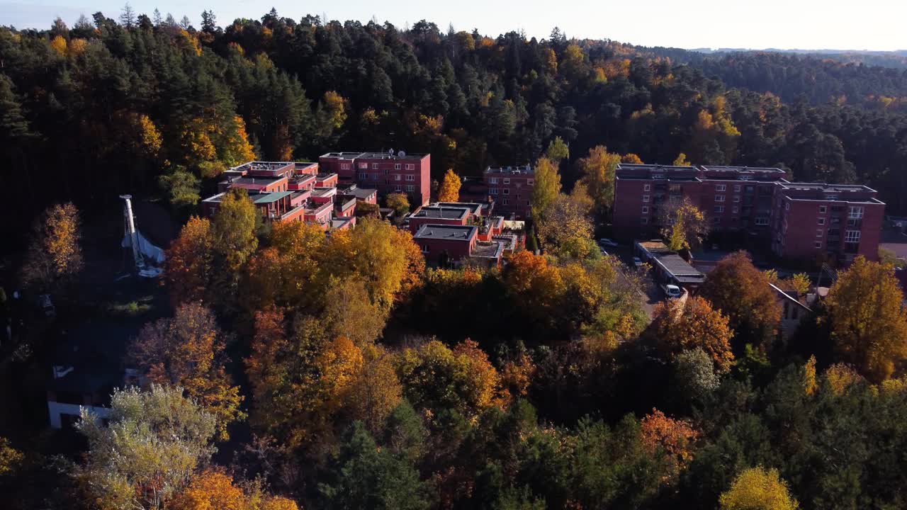 AERIAL Side Panning Shot of a Residential Area deep within an Autumn Forest in Antakalnis District, Vilnius, Lithuania